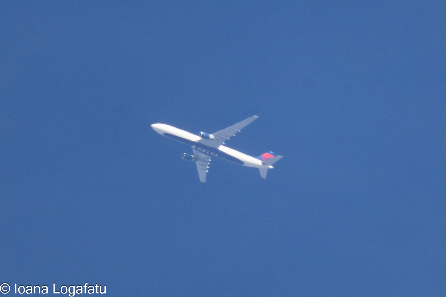 Airplane soaring through the clear blue sky